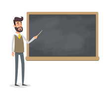 The Teacher In The Classroom Near The Blackboard Is Teaching A Lesson. A Young Professor At The University Is Giving A Lecture. A Man With A Beard With A Pointer Teaches