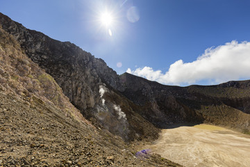 Morning sun hits the caldera at the summit of active stratovolcano, Mount Egon in Indonesia.