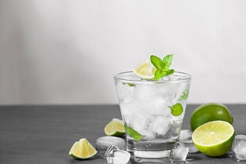 Wall Mural - Mojito cocktail with lime and mint in glass on a grey stone background