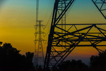 Electricity station. Close up high voltage power lines at sunset.