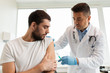 © Syda Productions - patient and doctor with syringe doing vaccination