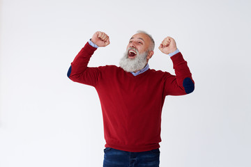 Wall Mural - Happy mature bearded man raising hands looking upwards, celebrating victory