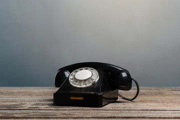 Poster - Vintage phone on a wooden table