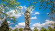 © elroce - Angel statue in a cemetery  with clouds and blue sky