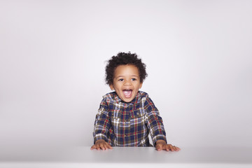 Portrait of a cute smiling african american little boy in checkered shirt  isolated on white background.