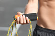 © Africa Studio - Young man holding jumping rope outdoors