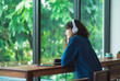 © weedezign - Happy asian casual woman listening music with headphones near window at cafe restaurant,Digital age lifestyle,chill out  life