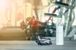 © Golden House Images - Cool water drinking on floor in fitness gym. Selective focus.