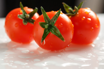 Wall Mural - Ripe tomatoes with green twig