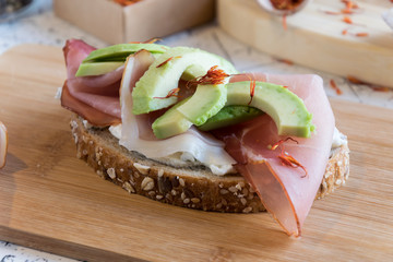 fresh bread with cottage cheese, prosciutto , avocado and saffron