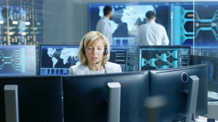 Leinwandbilder - System Monitoring Room Female Dispatcher Control Correct Functioning of the System. In the Background People Working with Interactive Map. Shot on RED EPIC-W 8K Helium Cinema Camera.