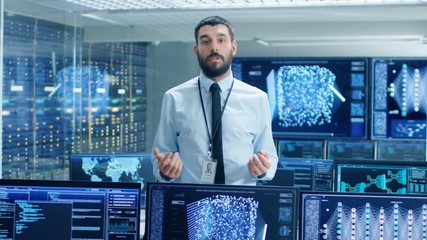 Fototapete - In the Machine Learning Engineering Laboratory Scientist Excitedly Describes Project He's Working on. Background Shows Screens with Functioning Neural Network/ Artificial Intelligence. 