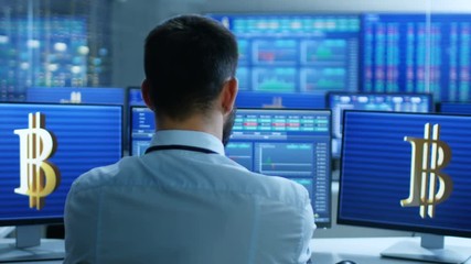 Fototapete - Stock Exchange Trader Works With Cryptocurrency at His Workstation. Screens Show Ticker Numbers and Graphs. Shot on RED EPIC-W 8K Helium Cinema Camera.