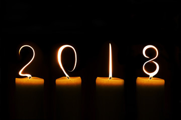 2018 written with candle flames on black background