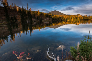 Wall Mural - Stnning sunset last golden light over alpine lake nad peaks