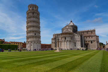 Wall Mural - Stunning daily view at the Pisa Baptistery, the Pisa Cathedral and the Tower of Pisa. They are located in the Piazza dei Miracoli (Square of Miracles) in Pisa, Italy. 