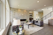 Modern Great Room With A Floor To Ceiling Stone Fireplace