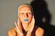 Young woman portrait with blue lips and clay in hair