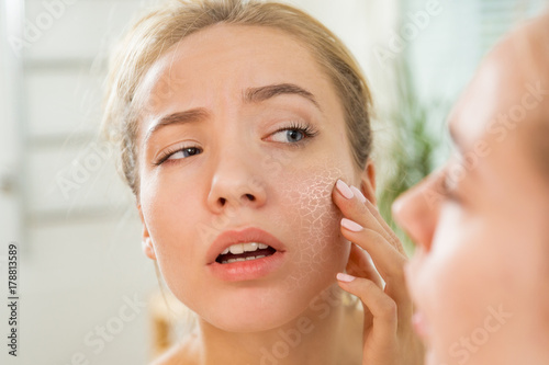 Cuadros en Lienzo Young beautiful woman touching skin in bathroom