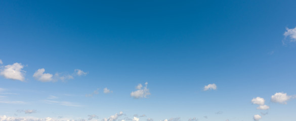 light blue sky with clouds. panorama white clouds flying against blue sky.