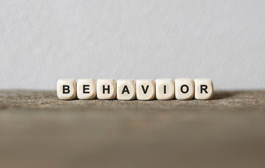 word behavior made with wood building blocks