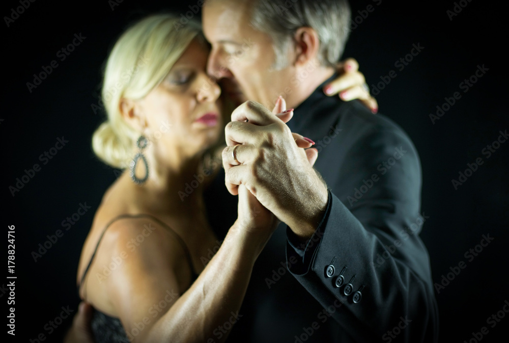 selective focus on two hands crossed of two adult tango dancers - obrazy, fototapety, plakaty 