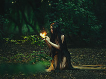 A Fabulous, Forest Nymph With Long Hair Found A Flaming, Fiery Flower, With Which Little Butterflies And Fairies Fly Out. Artistic Photography