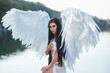 © kharchenkoirina - A beautiful white archangel descended from heaven. A girl in a sexy suit with huge white wings. Artistic Photography
