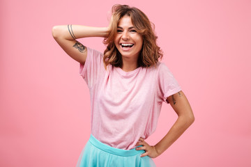 Poster - Cheerful young woman isolated over pink background posing