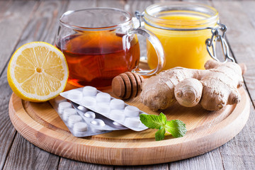 Wall Mural - Hot tea for colds, medicine and Honey on wooden table