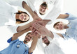 © ASDF - bottom view.a team of doctors at the medical center clasped their hands together