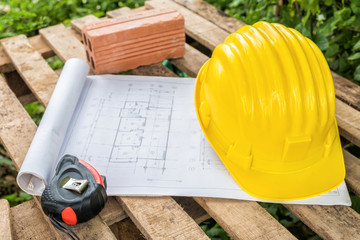 yellow safety helmet and measure tape