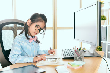 beautiful little business worker using calculator