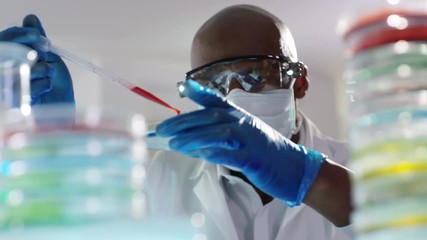 chemical research scientist working in the lab with colorful liquids