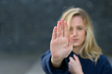 Young woman making a halt gesture