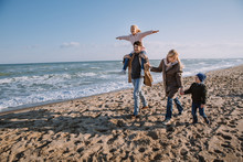 Family On Seashore In Autumn