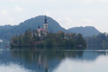 Saint Martin church in the fog on the island of Bled lake, Slovenia