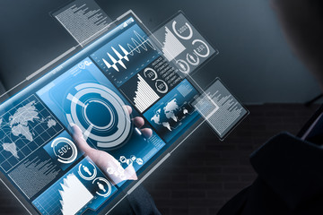 The abstract image of business man looking to the hologram on his smartphone in the night. the concept of communication, network, technologic, internet of things and business.