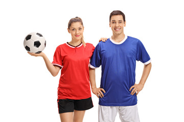 Female and male soccer players looking at the camera and smiling