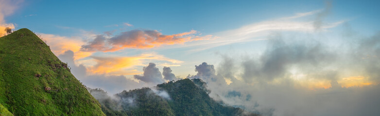 Panorama the beauty of the sky, forests, mountains and fog in the bright morning light. at Phu Miang, Udtaradit  Province,Thailand. subject is blurred.