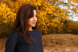 © milogrodskiy - Young girl standing in autumn wood in sportswear