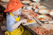 Little Cook. Children Make Pizza. Master Class For Children On Cooking Italian Pizza. Young Children Learn To Cook A Pizza. Kids Preparing Homemade Pizza