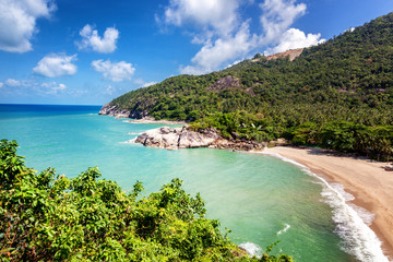 Wall Mural - Tropical beach and hills covered with palm trees, view from the top