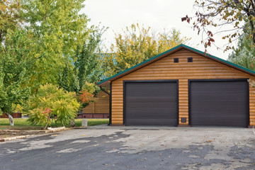 Small log cabin with 2 car garage built away from city in forest