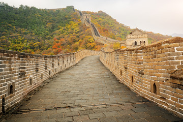 China The great wall distant view compressed towers and wall segments autumn season in mountains near Beijing ancient chinese fortification military landmark in Beijing, China.