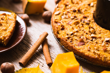 Wall Mural - Pumpkin pancakes on a wooden background. Autumn food