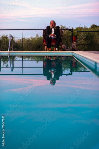Business Man With Long Grey Hair And Beard In Chair At