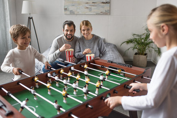 Wall Mural - siblings playing table football