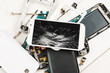 © Glevalex - Cell phone with broken display among disassembled gadgets