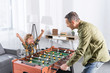 © LIGHTFIELD STUDIOS - father and son playing table football